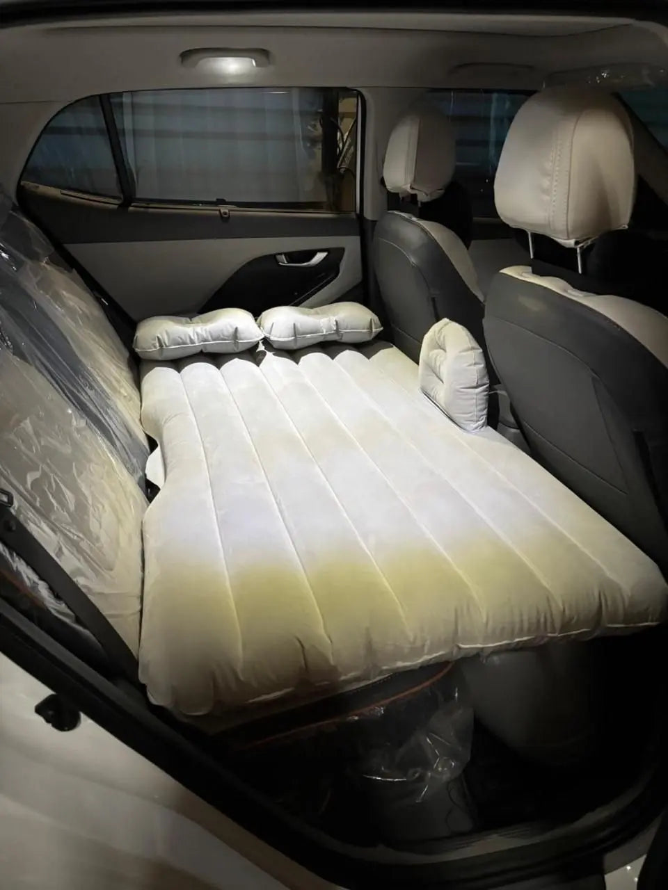 Portable car air mattress comfortably fits inside vehicle backseat for travel and camping convenience