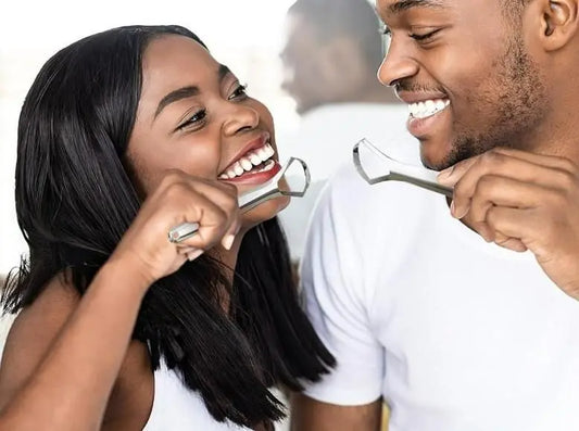 Couple using the best tongue cleaner for fresh breath with smiling faces in a bright setting
