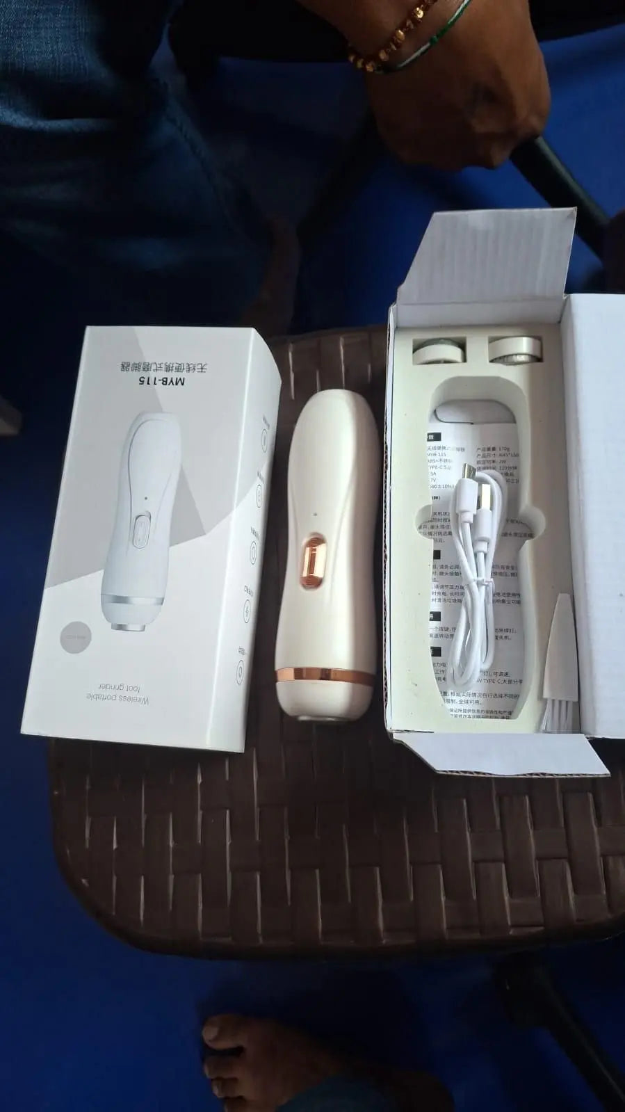 Electric foot scrubber from Trandingstor.shop with packaging, charging cable, and user manual
