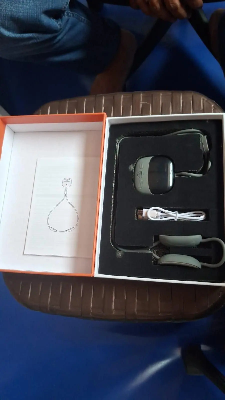 Portable neck massager in a box with charging cable and user manual for relaxation and pain relief