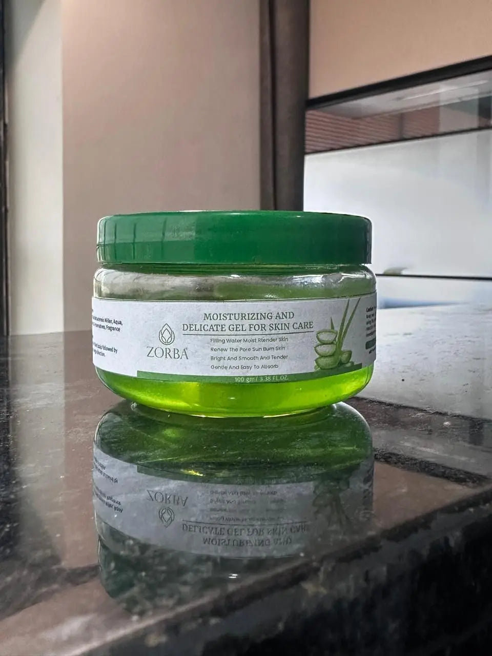 Zorba Moisturizing and delicate skin care gel in a green jar on a marble surface
